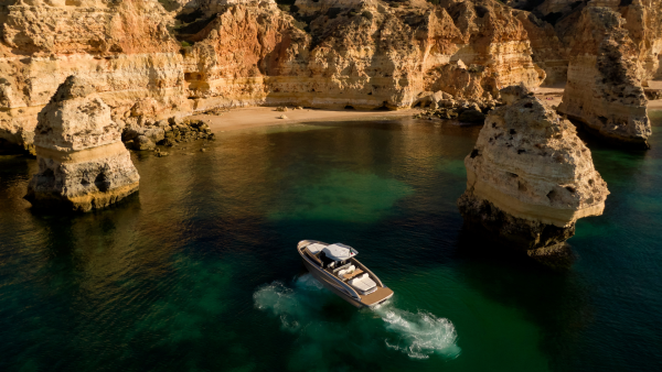 Experience the beauty of the Algarve coast with a scenic cruise in Portugal. Crystal-clear turquoise waters stretch to the horizon, bordered by dramatic cliffs and golden sandy beaches. Passengers aboard the cruise boat enjoy panoramic views of the stunning coastline, dotted with picturesque caves and rock formations. Explore the Algarve's natural wonders and indulge in the tranquility of the sea on this unforgettable journey.